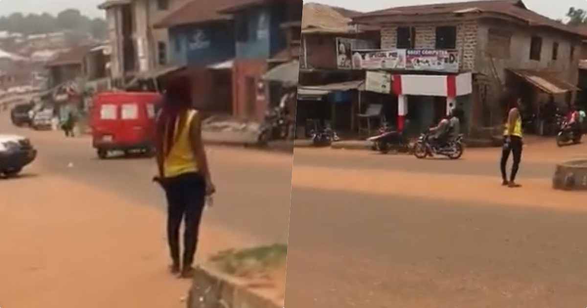 Lady allegedly goes insane after dropping from a car in Auchi (Video)