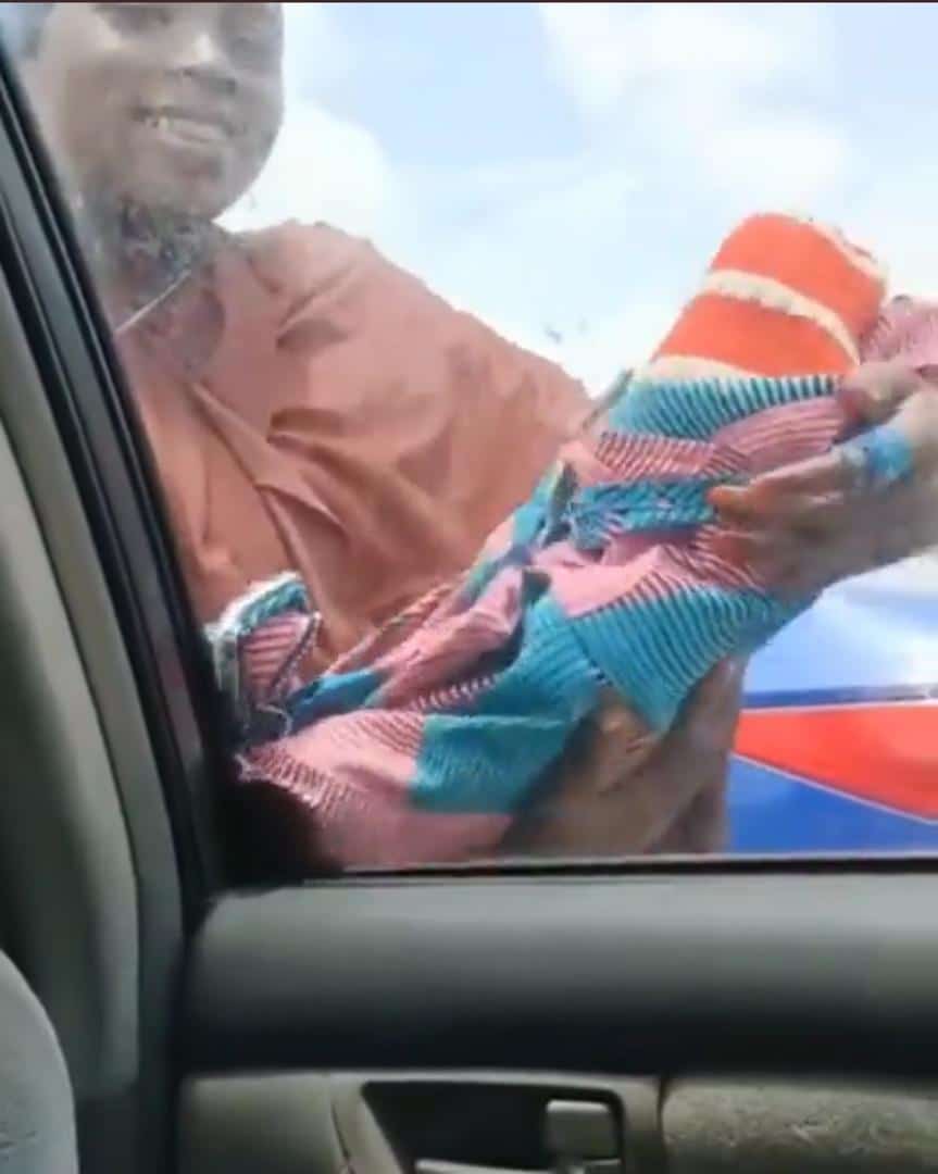 Lady spotted begging for alms with 'fake baby' (Video)