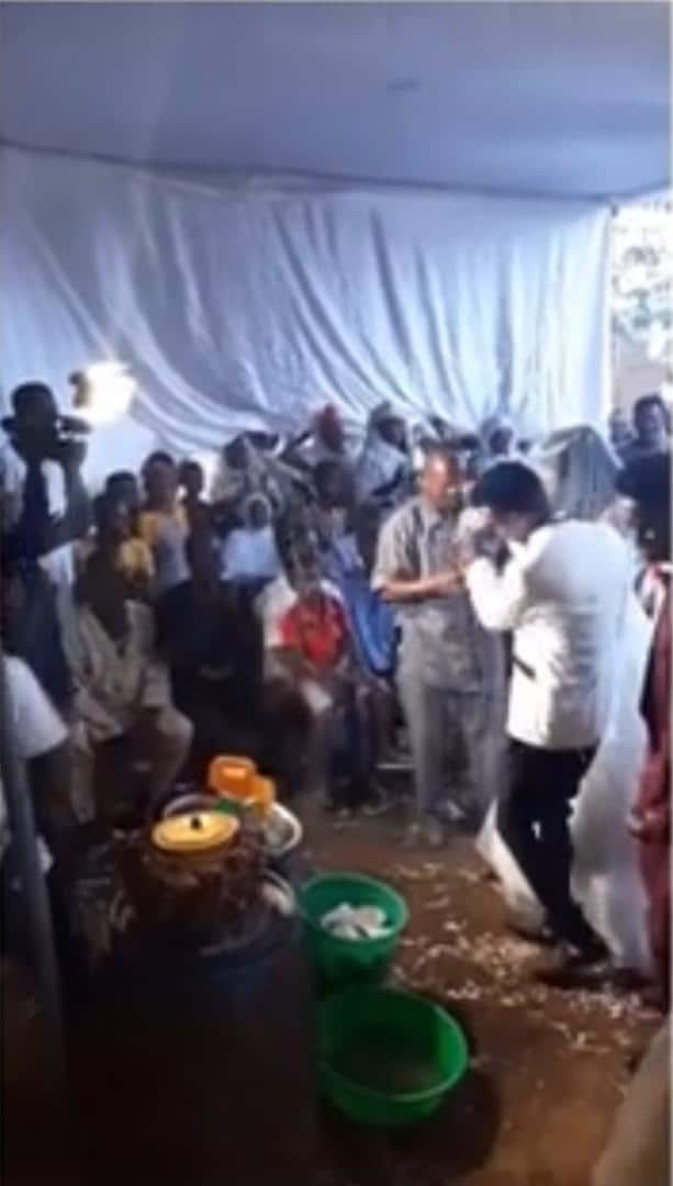 Chaos as groom fights man for spraying him money at his wedding (Video)