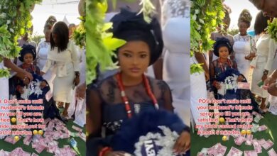 "If I laugh, make I bend" - Bride refuses to smile until groom, friends shower her with cash on wedding day