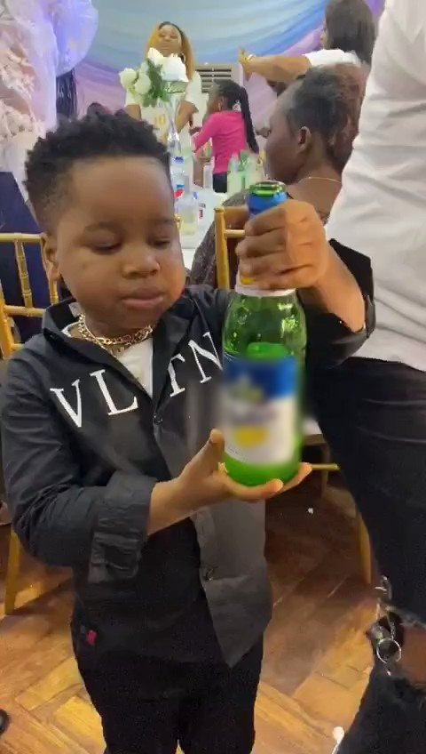 Boy consumes beer at a party