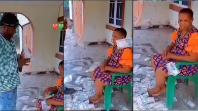 Mother acts unbothered as son sprays her loads of cash (Video)