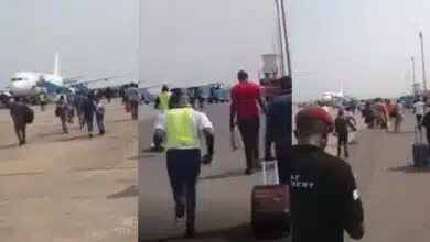 Airport passengers running board plane