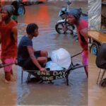 Man wheel barrow flooded