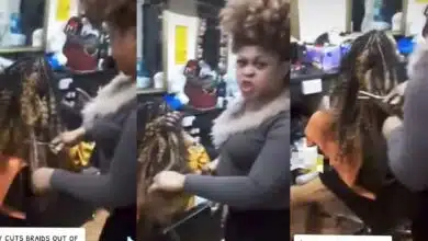 Hairstylist cuts customer's hair