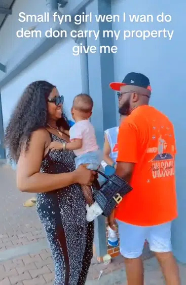 Wife causes buzz as she tries to form slay queen in public, husband quickly hands her their baby, she reacts