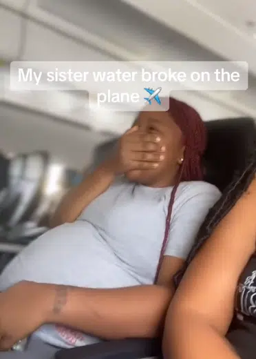 Moment pregnant woman water breaks on Aeroplane