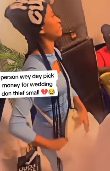 "Someone's serious babe" - Video of lady stealing couple's money at wedding causes buzz