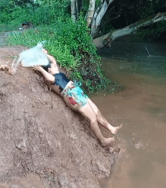 Video of Oyinbo Lady who fell back into stream while fetching water goes viral
