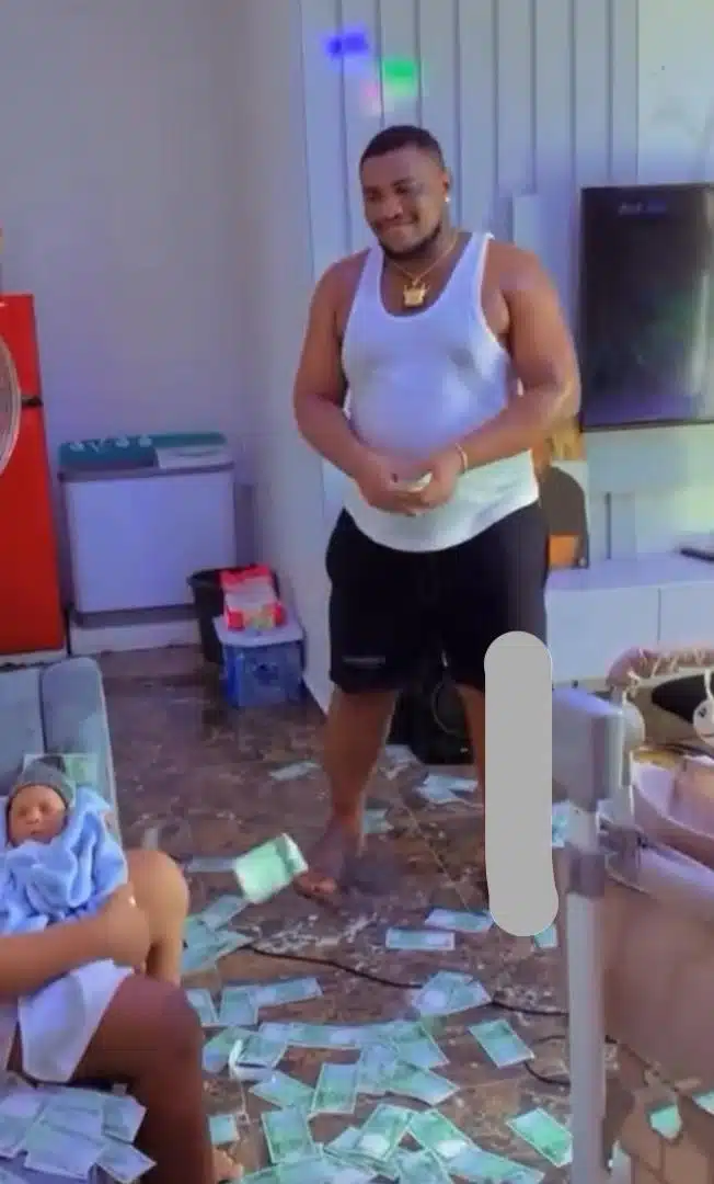 Happy father sprays wife and newborn baby with money