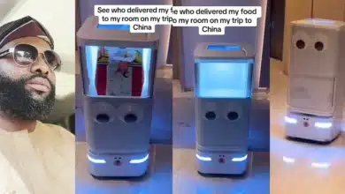 Man awed as robot delivers his food to his hotel in China