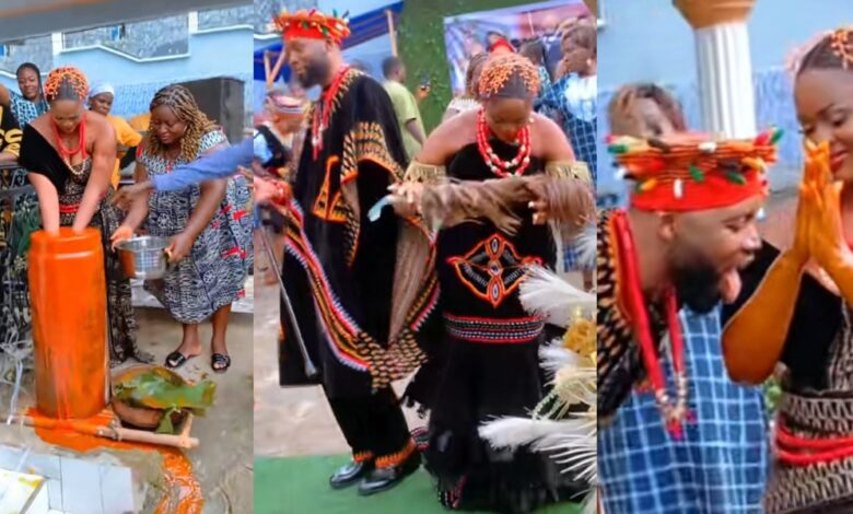 Beautiful bride dips hand in drum of palm oil, husband licks it off with tongue in traditional marriage ritual