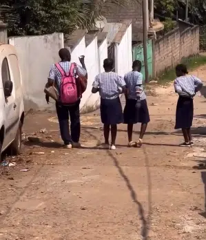 young boy bags female classmates 
