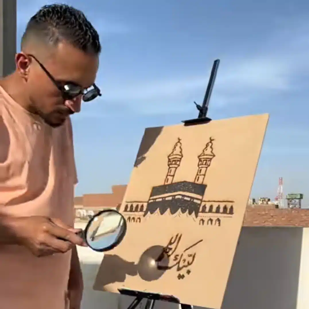 Egyptian artist goes viral for creating Mecca image using sun's heat and magnifying lens