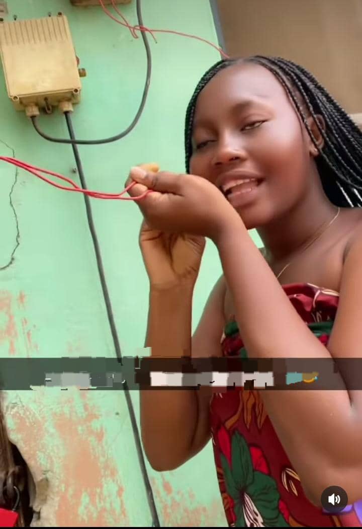 Lady displays her female friend's electrical skills as she fixes hostel's lighting issues