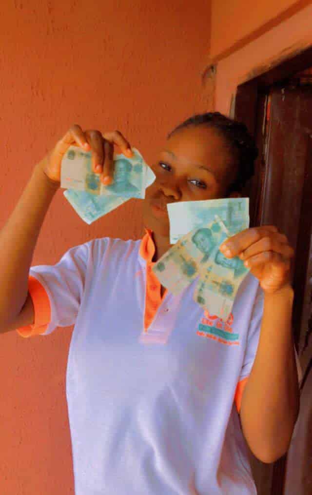 Lady joyfully flaunts foreign currencies she found in sweater she bought