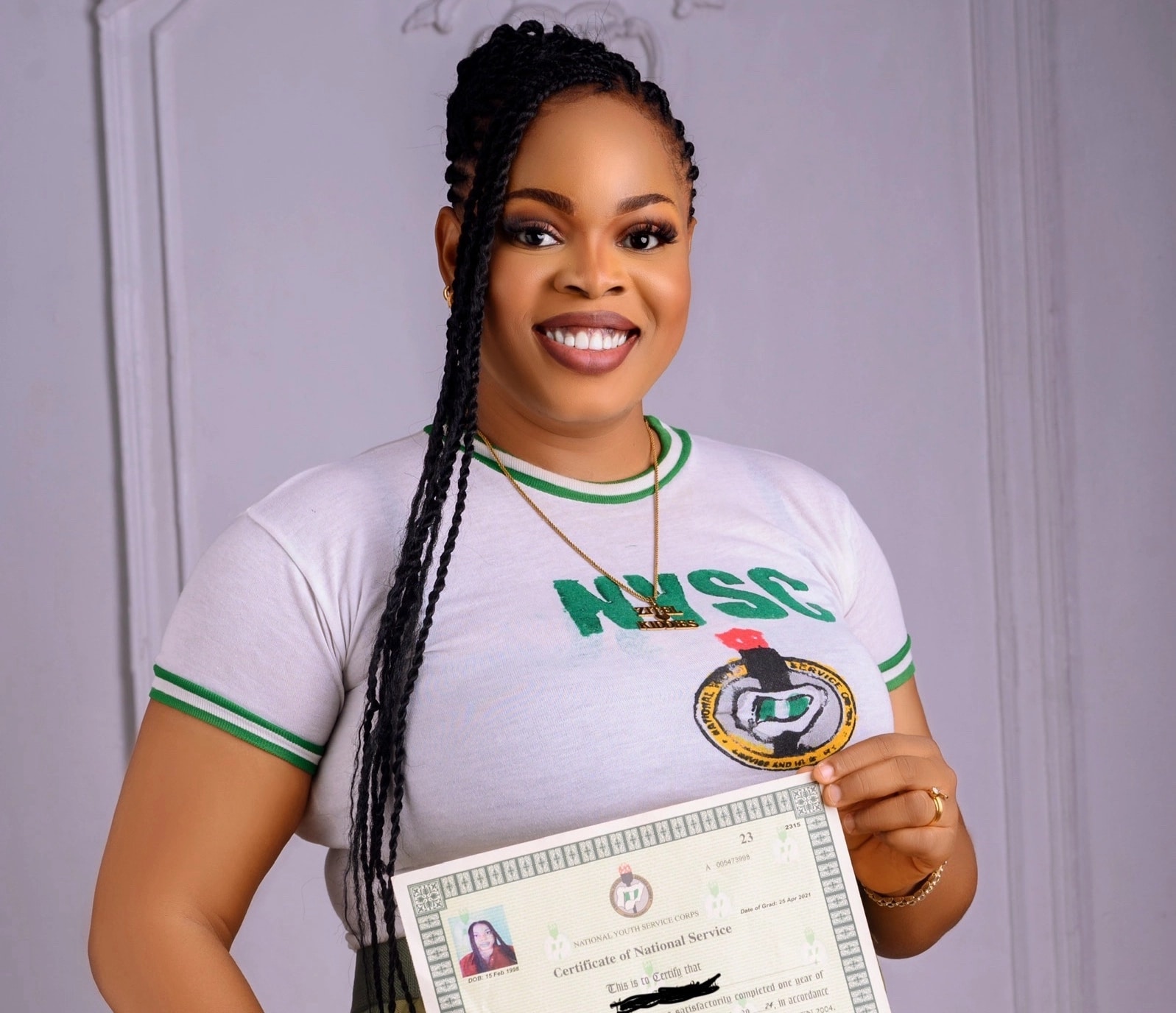 Nigerian woman celebrates NYSC completion with kids in matching uniforms