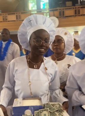 Lady dances joyfully as she celebrates her graduation in church, carries tray of dollars