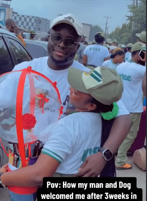 Female corper receives warm welcome from boyfriend and dog after NYSC camp