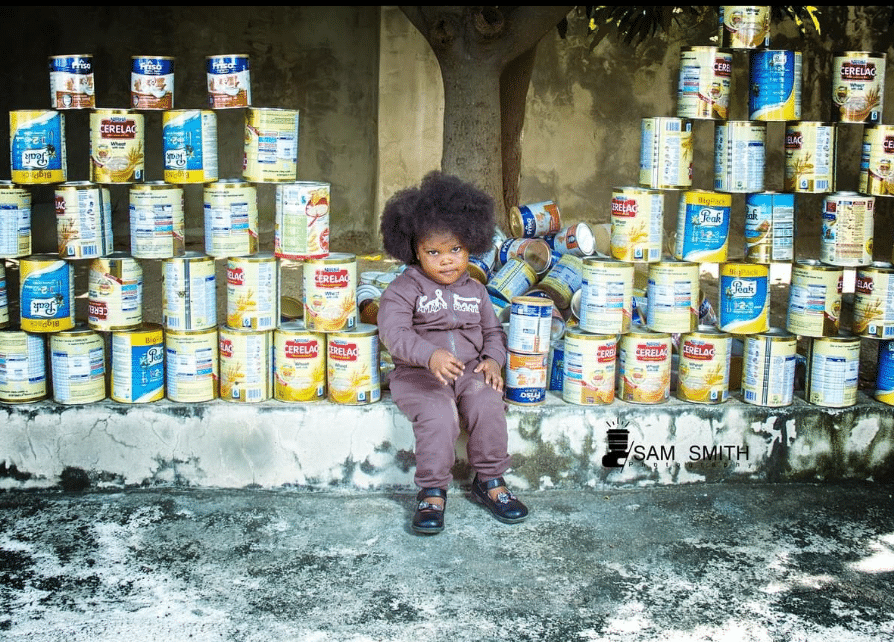 Man displays 'towering' stack milk tins his daughter consumed at 2