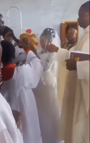 Moment priest gives altar boy 'heavy' knock for not keeping microphone steady during wedding