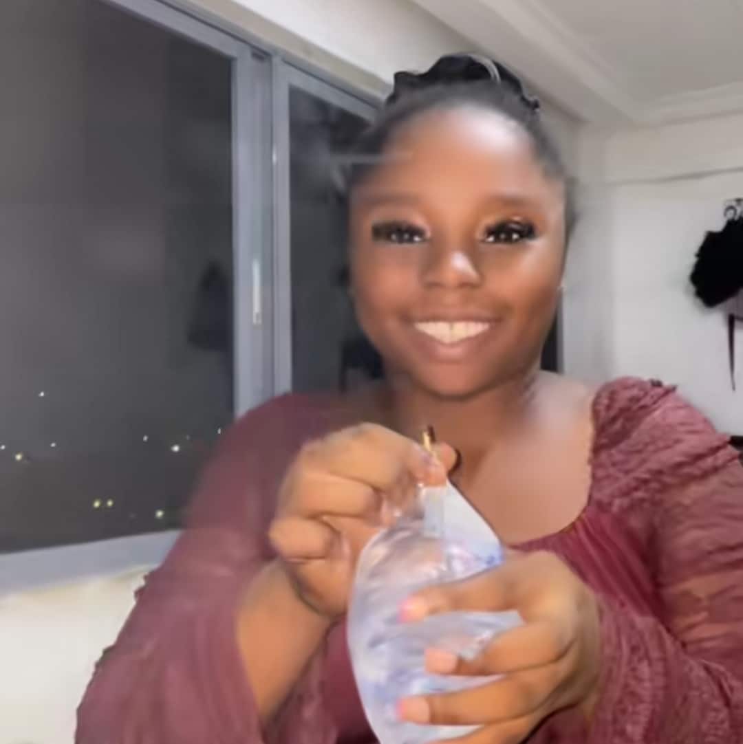 Nigerian lady marks her birthday with sachet water and a matchstick