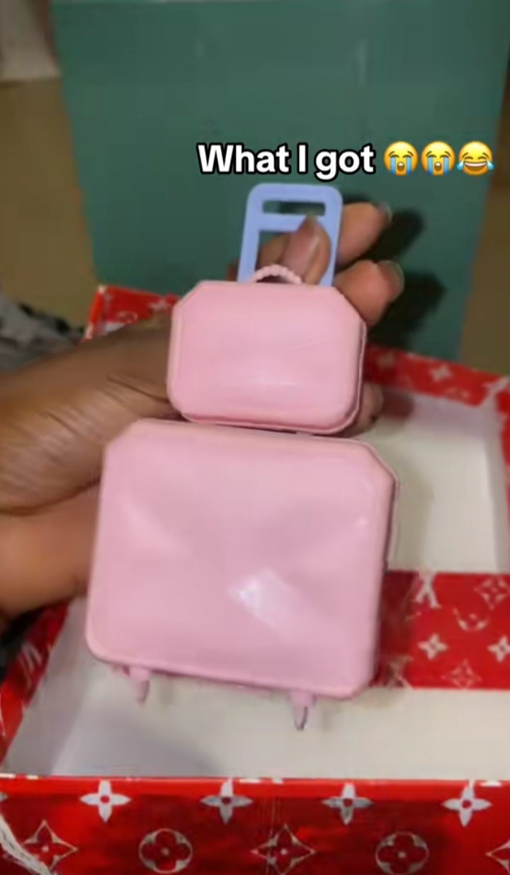 Lady in tears as she displays luggage she received after buying from online store