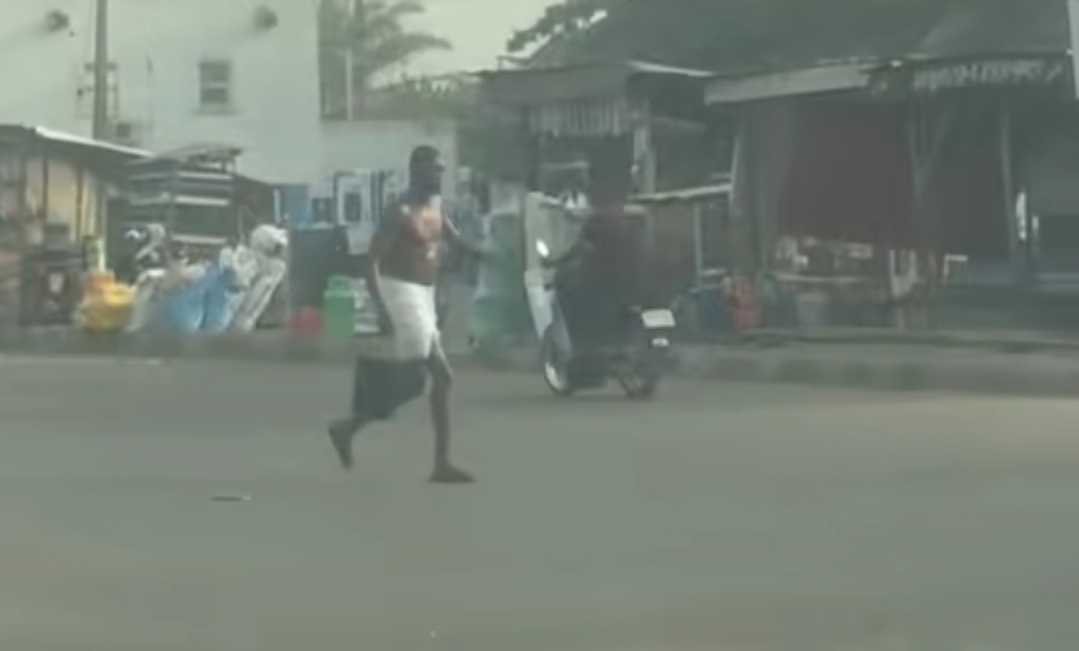 Outrage as man bathes in the middle of public road 