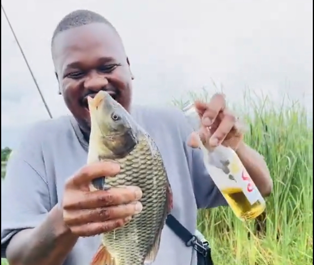 Outrage as man captures fish and pours drink into its mouth