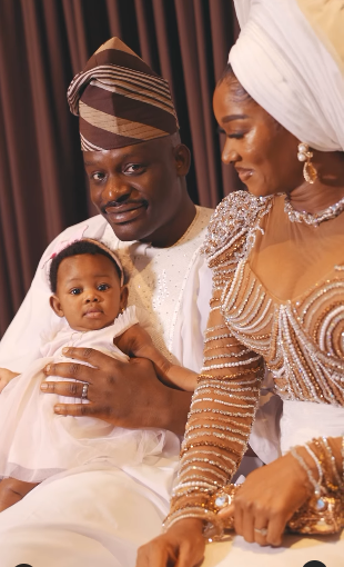 Wofai Fada and Taiwo Cole unveil their baby's face as they celebrate her dedication 