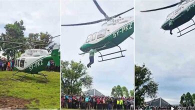 Shocking moment as man hangs onto helicopter mid-air